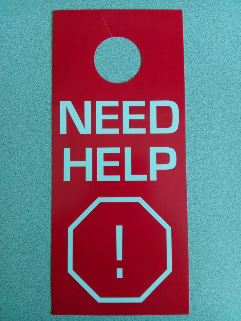 The red NEED HELP card a household displays when someone inside needs assistance.